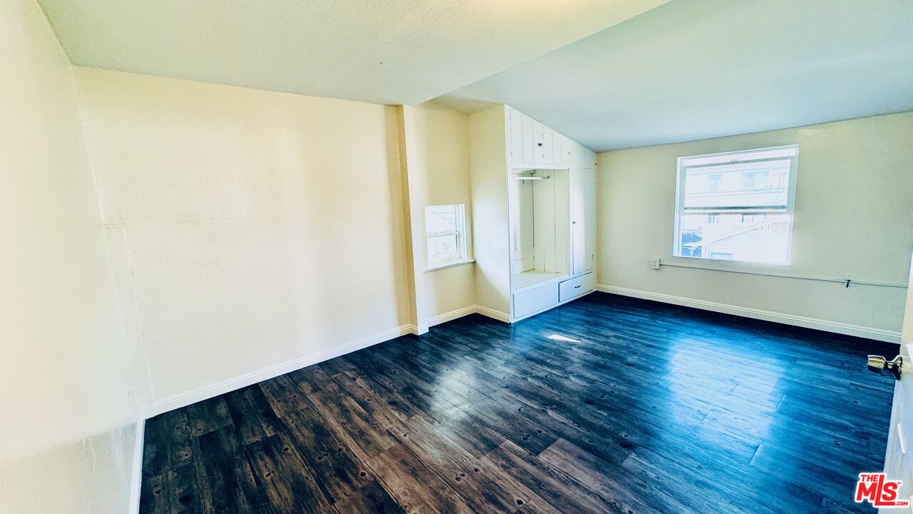 219 East 10th Street Long Beach, CA 90813 - Photo 7 of 26 an empty room with wooden floor and windows