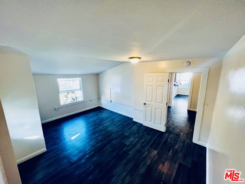 219 East 10th Street Long Beach, CA 90813 - Photo 8 of 26 an empty room with wooden floor and window
