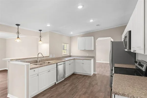a kitchen with a sink stove and refrigerator