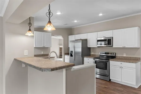 a kitchen with stainless steel appliances granite countertop a sink stove and refrigerator