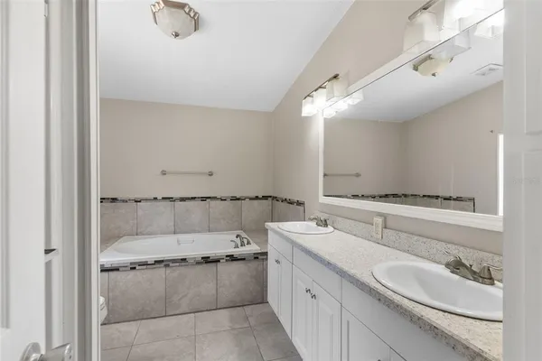 a bathroom with a double vanity sink and mirror