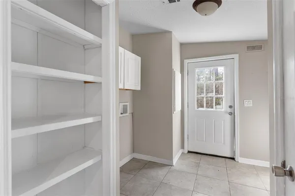a view of an empty room with closet
