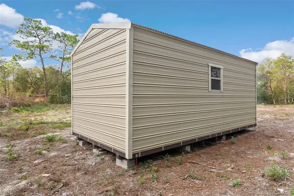 a view of a small house and a yard