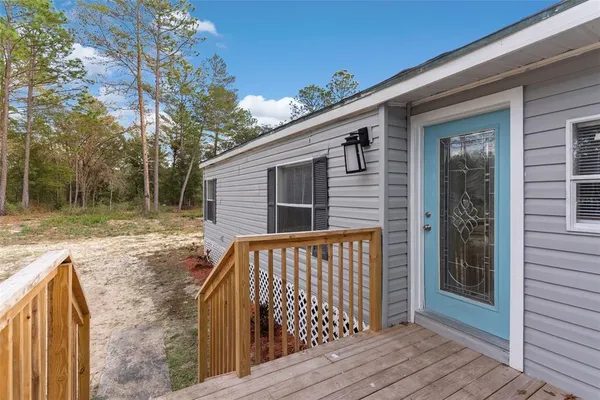 a view of backyard with deck and wooden floor