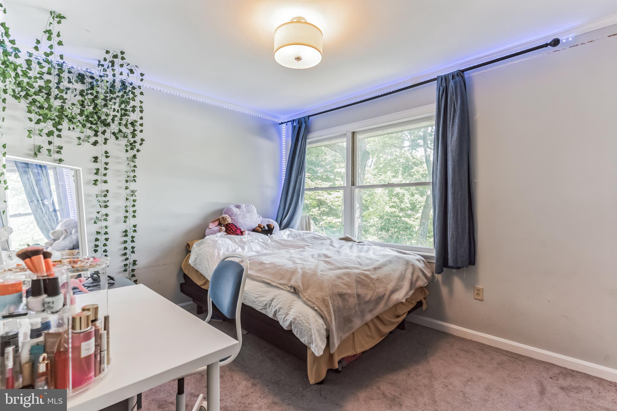 9329 Harvey Road Silver Spring, MD 20910 - Photo 21 of 40 a bed sitting in a bedroom next to a window