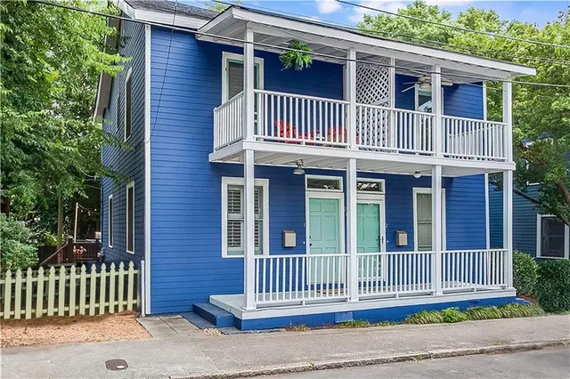 a view of a house with a small deck