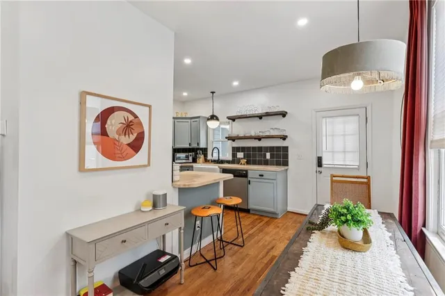 a kitchen with stainless steel appliances kitchen island granite countertop a stove a sink and a refrigerator