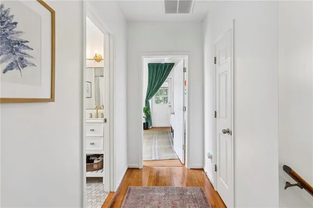 a view of a hallway view with wooden floor and living room