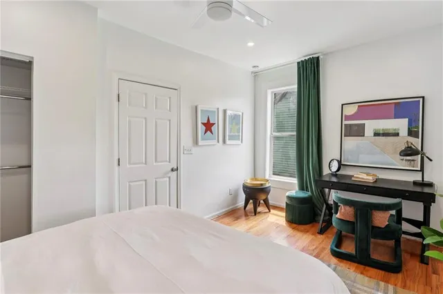 a spacious bedroom with a bed and a desk