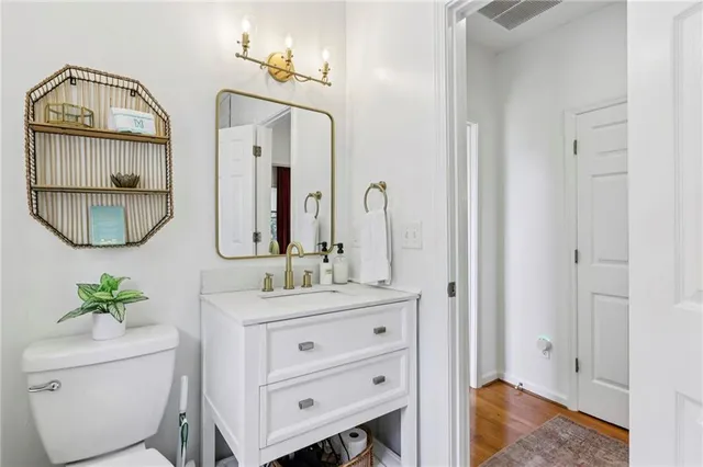 a bathroom with a toilet a sink and a mirror