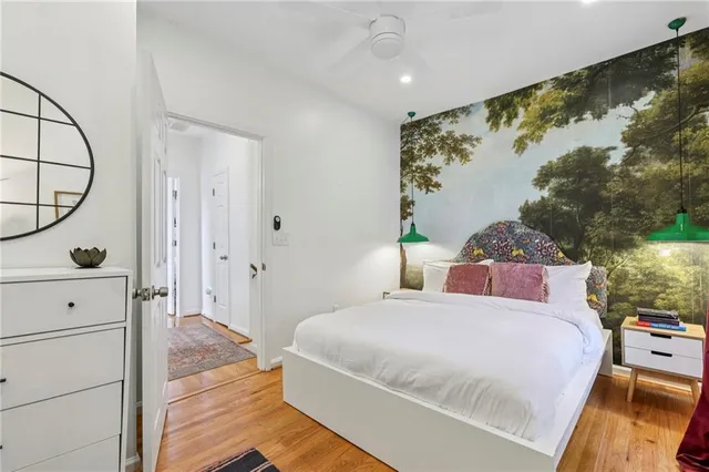 a bedroom with a bed and a painting on the wall