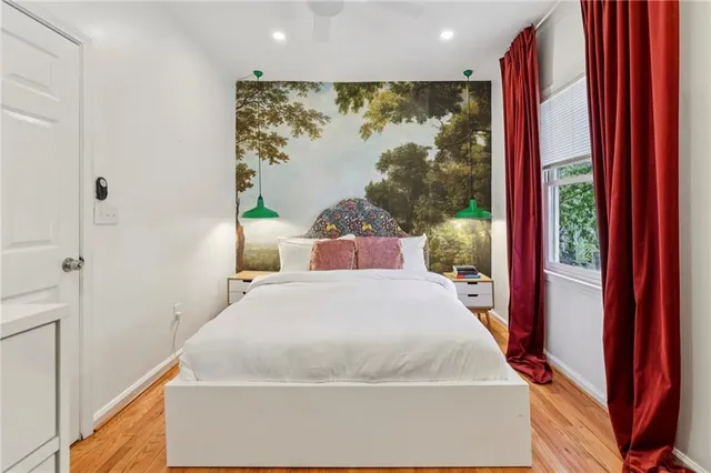 a bed sitting in a bedroom next to a window