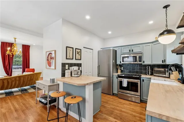 a kitchen with stainless steel appliances granite countertop a stove and a sink