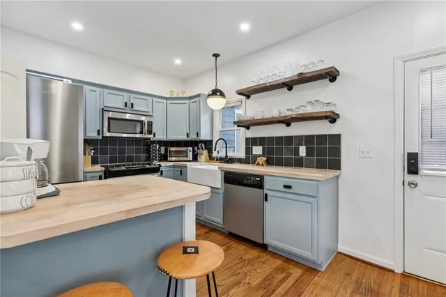 a kitchen with stainless steel appliances kitchen island granite countertop a sink and cabinets