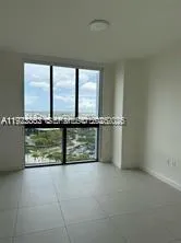 an empty room with sliding door and mountain view