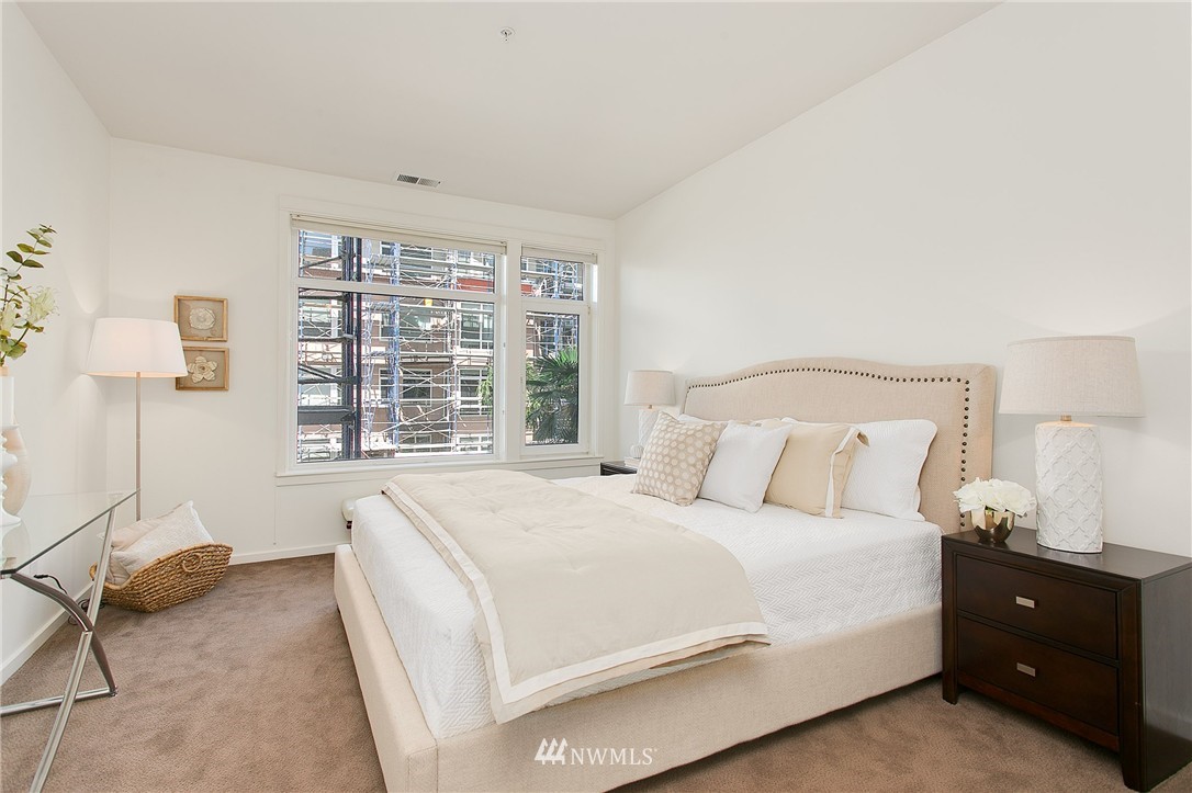 1950 Alaskan Way, Unit 237 Seattle, WA 98101 - Photo 11 of 20 a bedroom with a bed and a window
