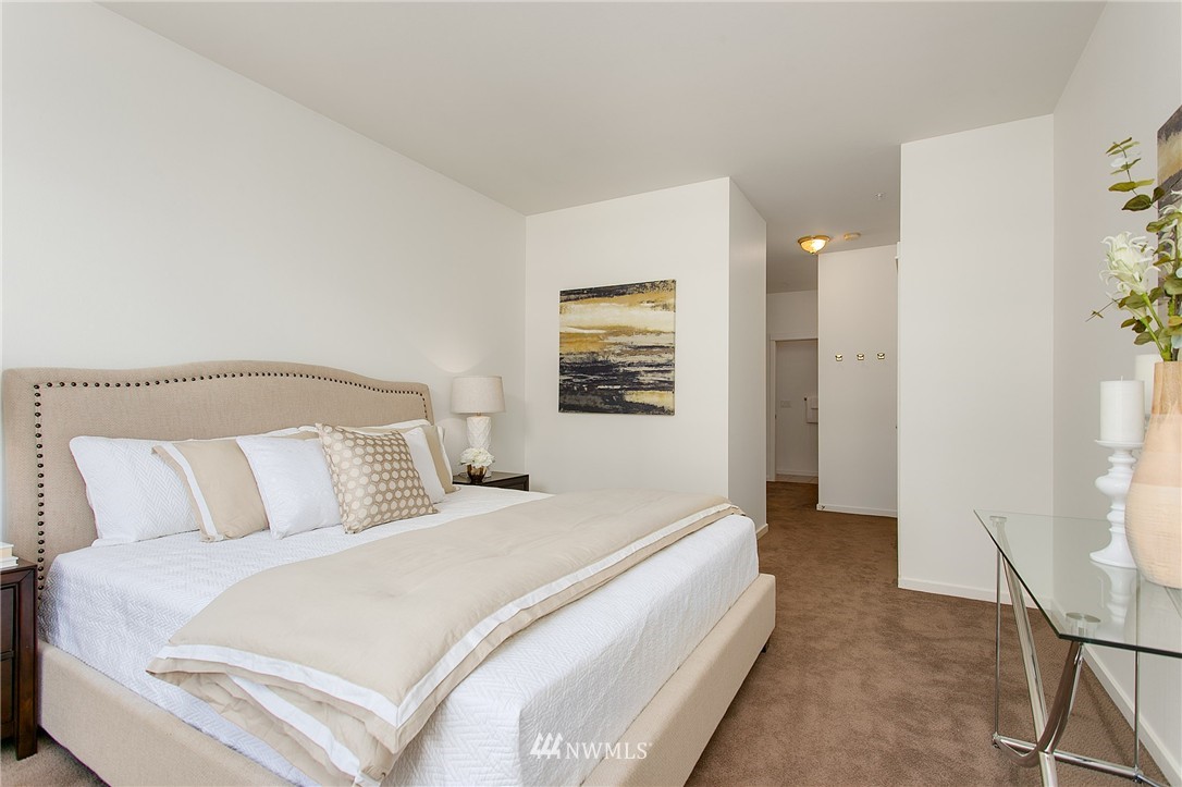 1950 Alaskan Way, Unit 237 Seattle, WA 98101 - Photo 12 of 20 a bedroom with a bed and a window