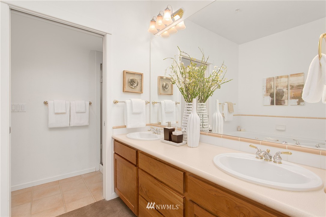 1950 Alaskan Way, Unit 237 Seattle, WA 98101 - Photo 13 of 20 a bathroom with a sink a vanity and a mirror
