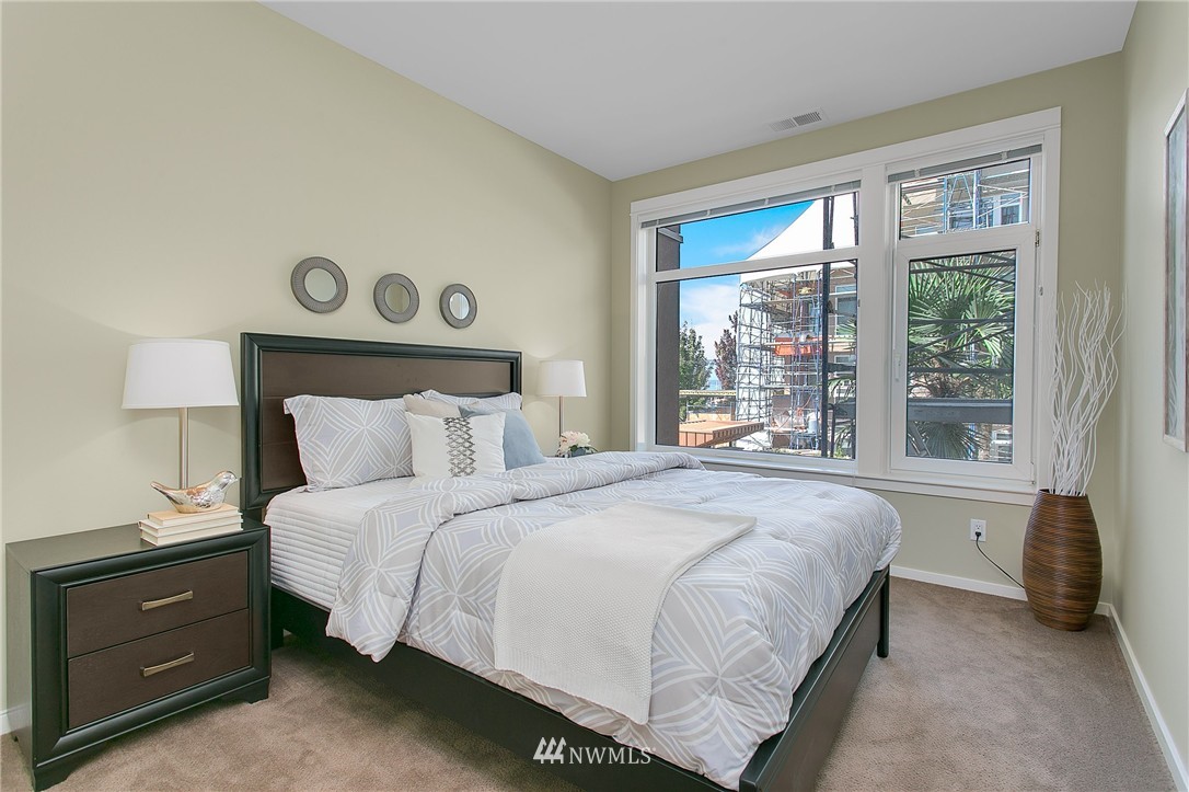 1950 Alaskan Way, Unit 237 Seattle, WA 98101 - Photo 15 of 20 a bedroom with a bed and a window