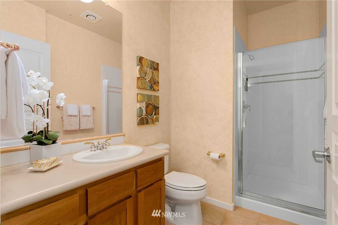 1950 Alaskan Way, Unit 237 Seattle, WA 98101 - Photo 16 of 20 a bathroom with a sink a toilet and shower