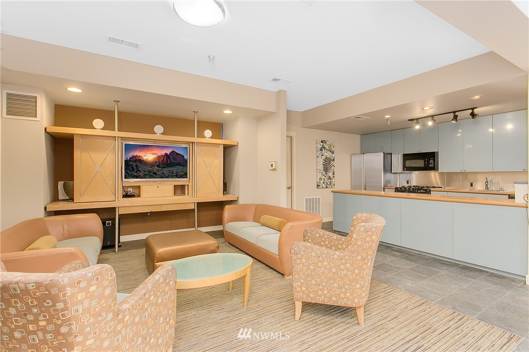 1950 Alaskan Way, Unit 237 Seattle, WA 98101 - Photo 18 of 20 a living room with furniture and kitchen view