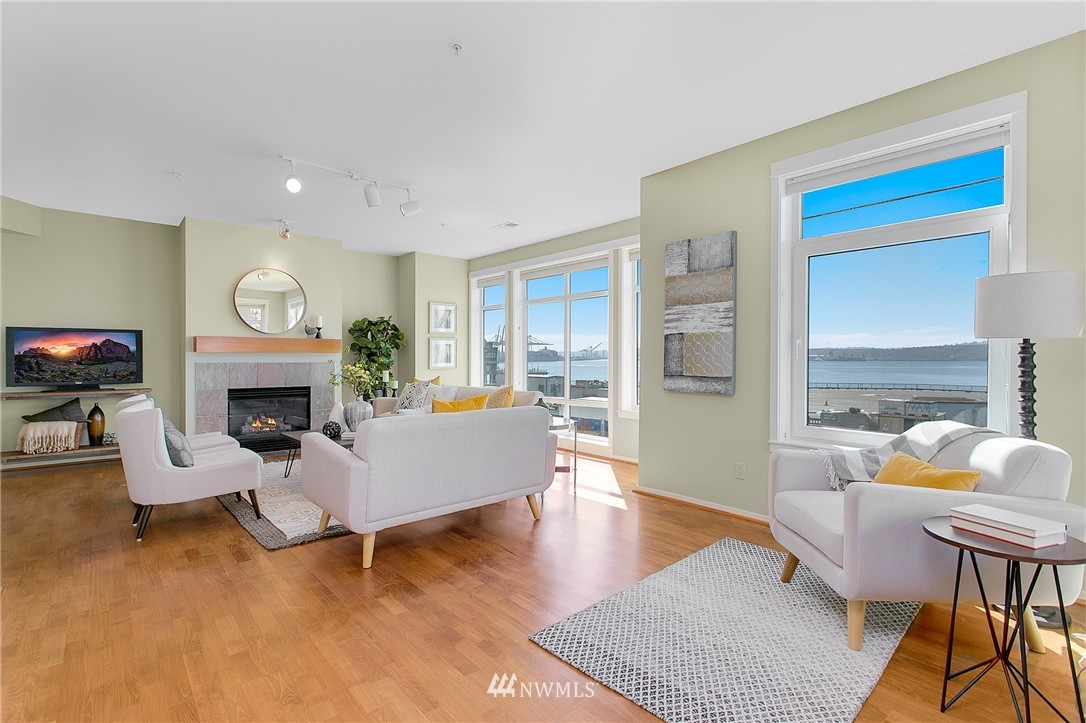 1950 Alaskan Way, Unit 237 Seattle, WA 98101 - Photo 3 of 20 a living room with furniture fireplace and a fireplace