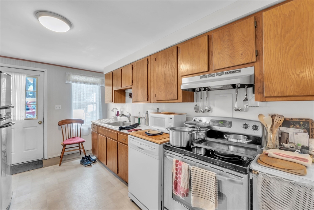 228 Walnut Hill Road Orange, MA 01364 - Photo 6 of 20 a kitchen with stainless steel appliances granite countertop a stove top oven a sink dishwasher and cabinets with wooden floor