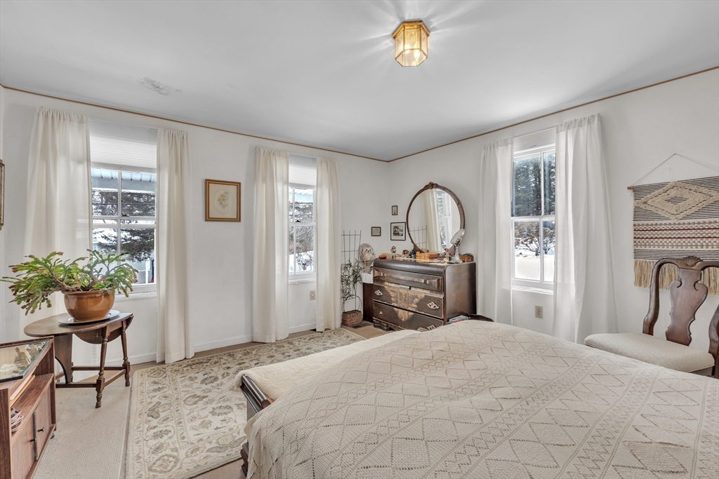 228 Walnut Hill Road Orange, MA 01364 - Photo 9 of 20 a bedroom with a bed and a potted plant