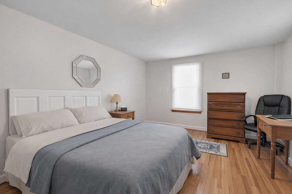 228 Walnut Hill Road Orange, MA 01364 - Photo 10 of 20 a bedroom with a bed and wooden floor