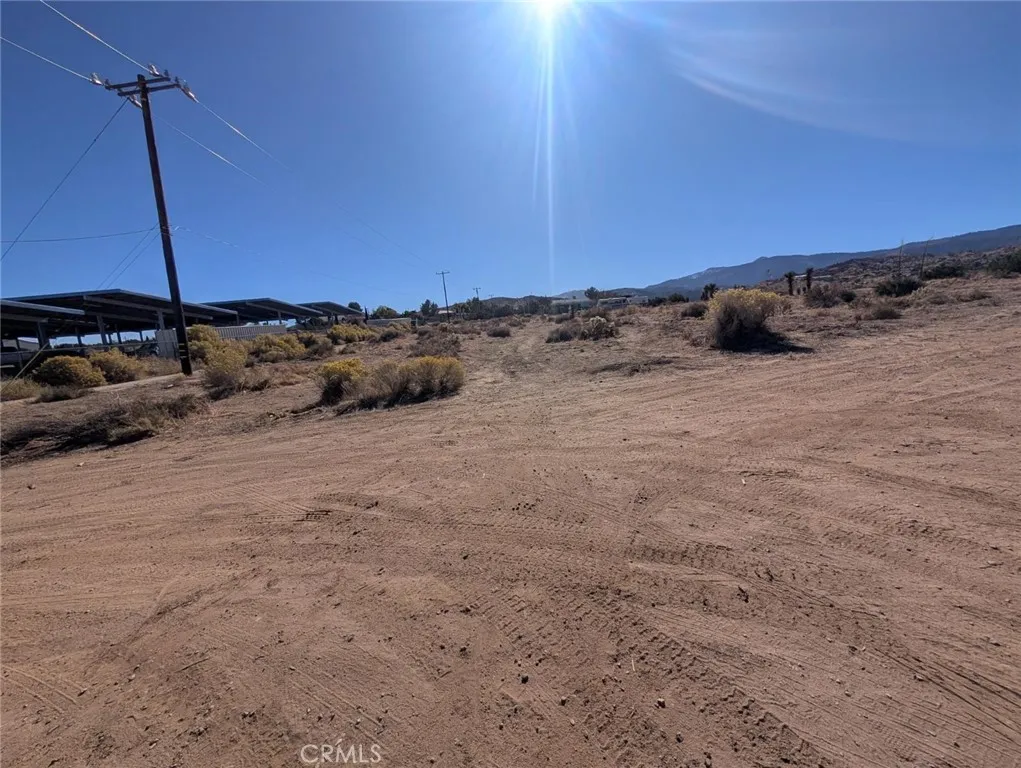 0 Malpaso Road Phelan, CA 92371 - Photo 7 of 19 a view of a dry yard with wooden fence