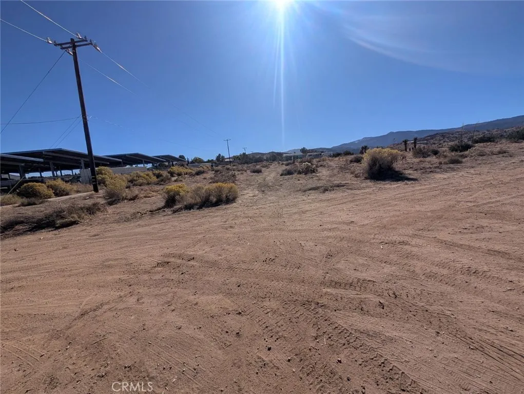 0 Malpaso Road Phelan, CA 92371 - Photo 7 of 19 a view of a dry yard with wooden fence
