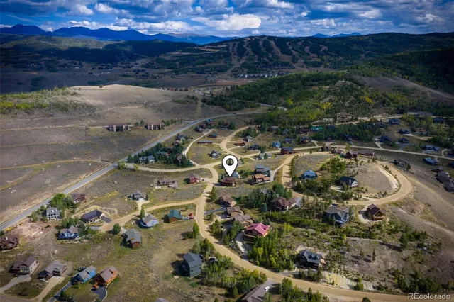 an aerial view of a house with a yard