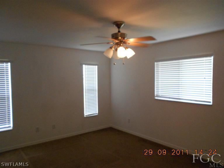 217 Rue Labonne Road Fort Myers, FL 33913 - Photo 4 of 8 a view of a livingroom with a ceiling fan and window