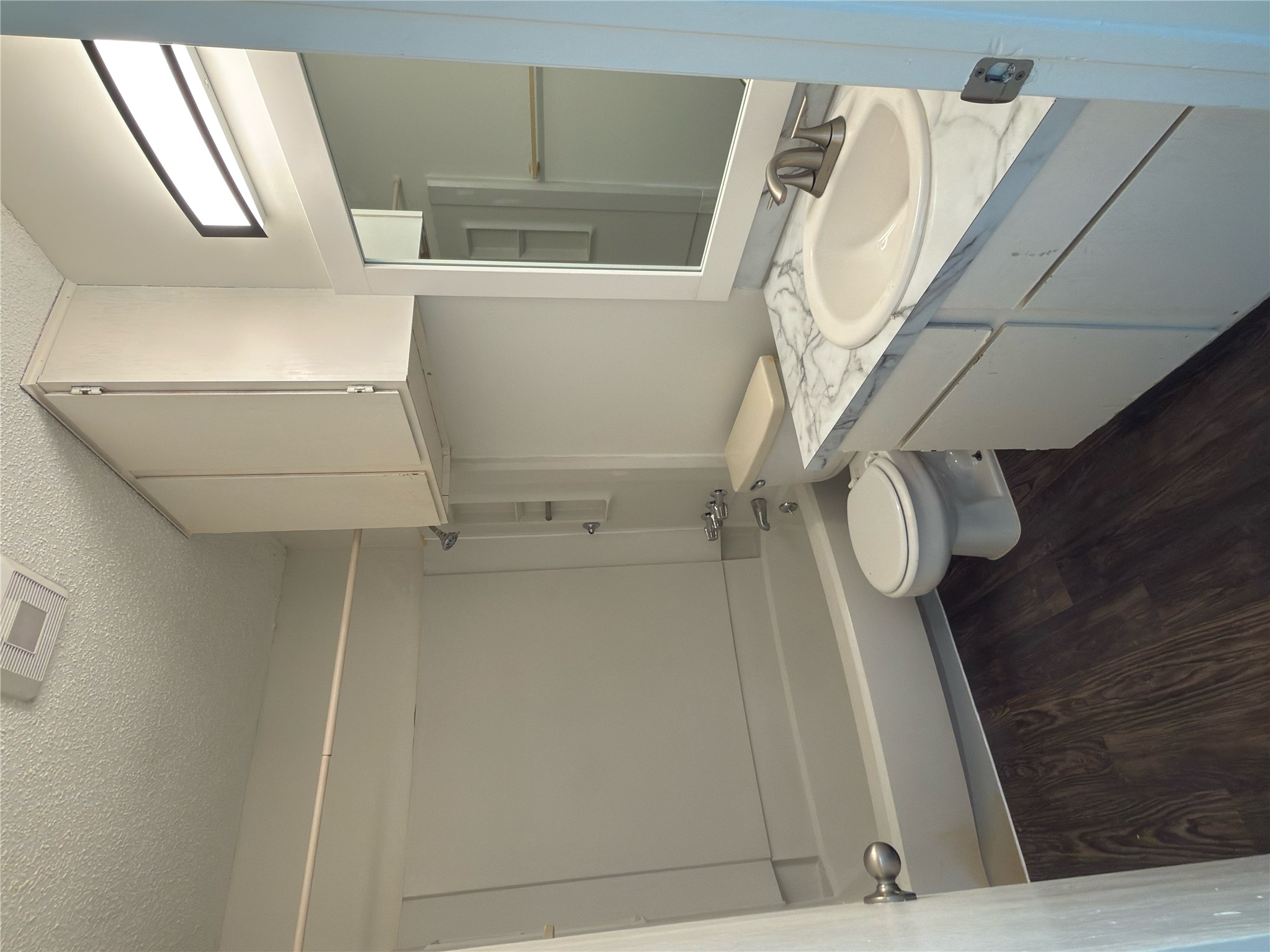 11807 Alpheus Avenue, Unit B Austin, TX 78759 - Photo 14 of 16 Full bath with a textured ceiling, vanity, dark wood-type flooring, and bathtub / shower combination