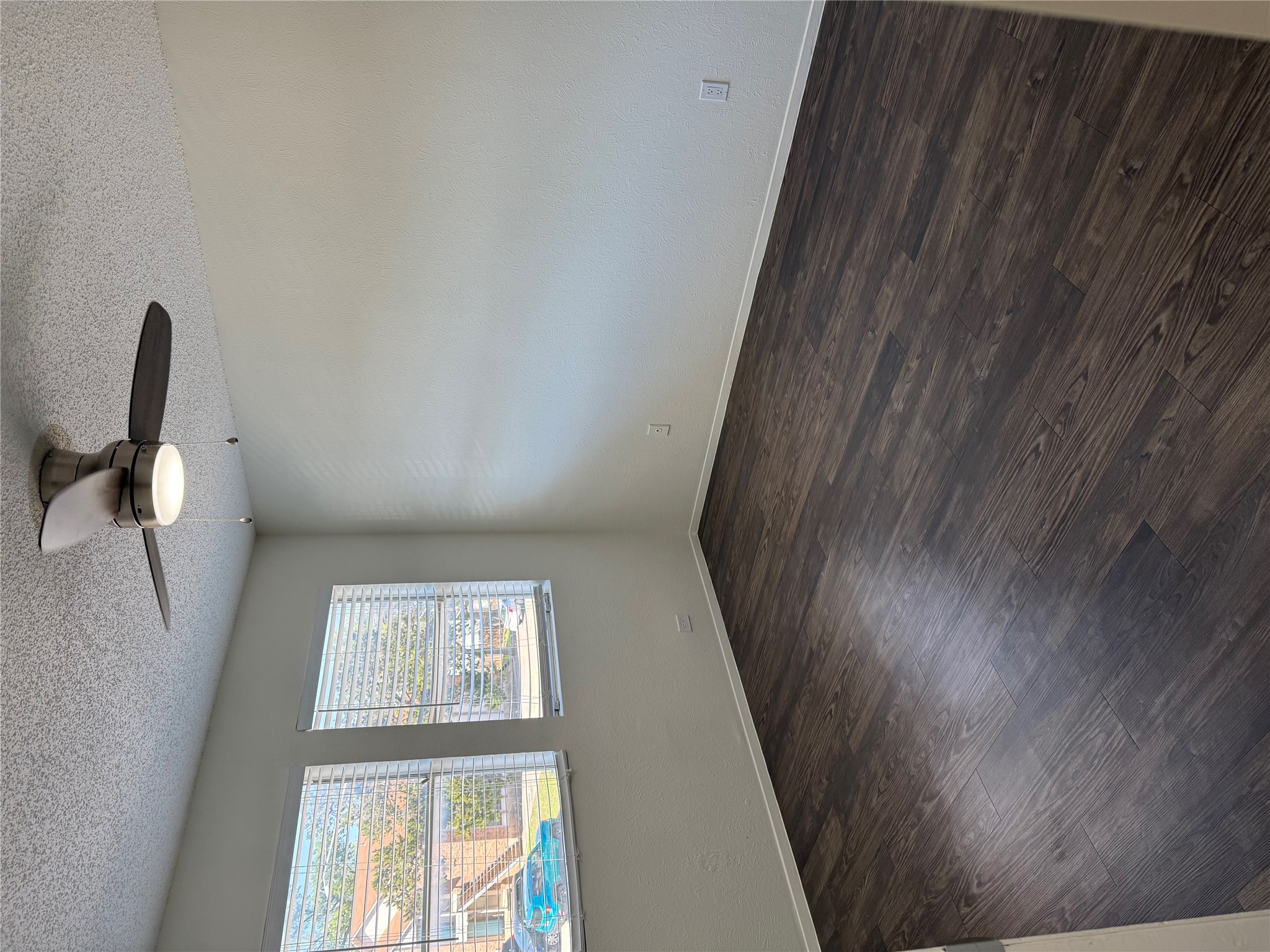 11807 Alpheus Avenue, Unit B Austin, TX 78759 - Photo 15 of 16 Unfurnished room featuring a textured ceiling, a ceiling fan, and dark wood-type flooring
