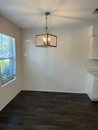 a view of a room with wooden floor and windows