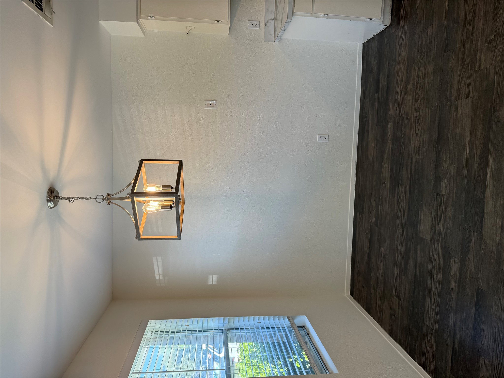 11807 Alpheus Avenue, Unit B Austin, TX 78759 - Photo 3 of 16 Unfurnished dining area featuring hanging lights and dark wood-style flooring