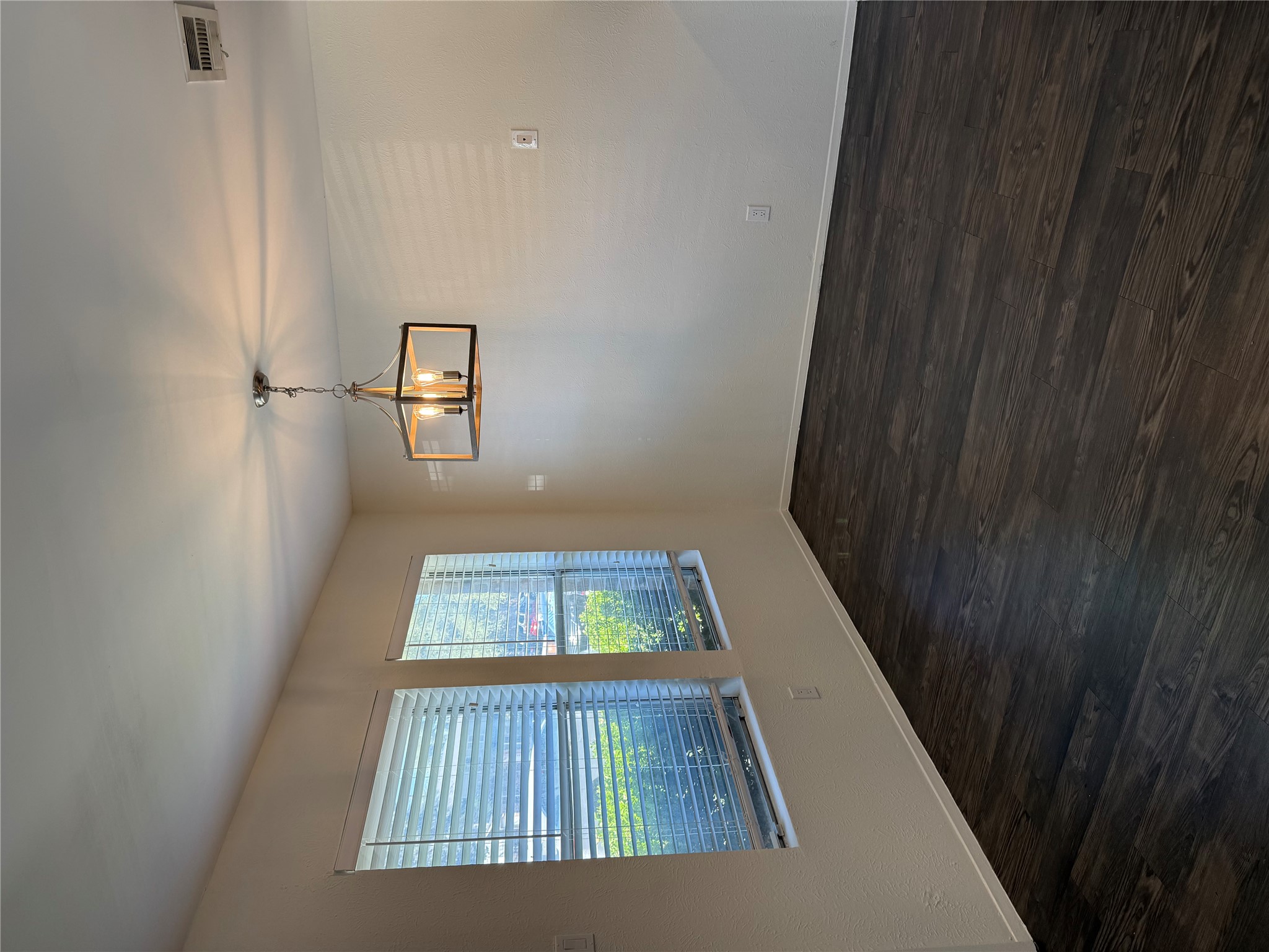 11807 Alpheus Avenue, Unit B Austin, TX 78759 - Photo 4 of 16 Spare room with a chandelier and dark wood-style floors