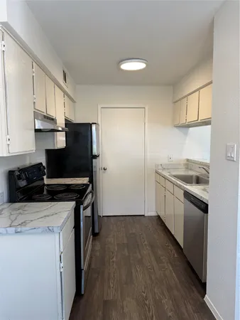 a kitchen with a sink stove and refrigerator