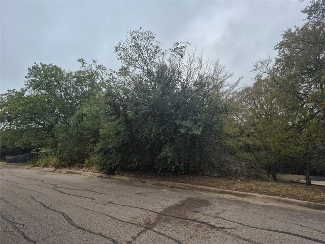 view of a field with trees in the background