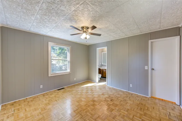 a view of a room with a ceiling fan and a window