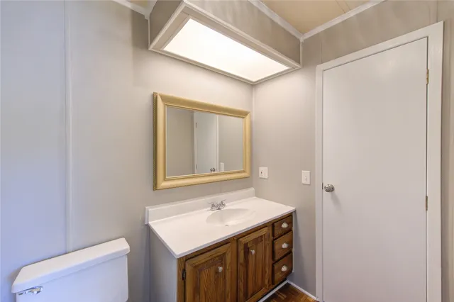 a bathroom with a sink a toilet and mirror