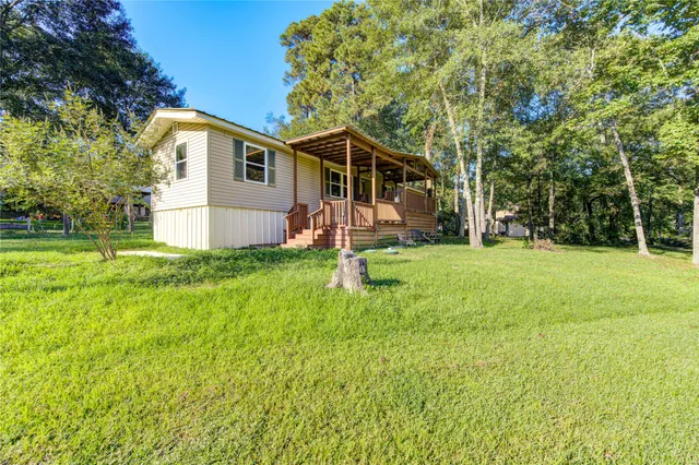 a view of a house with a yard and sitting area
