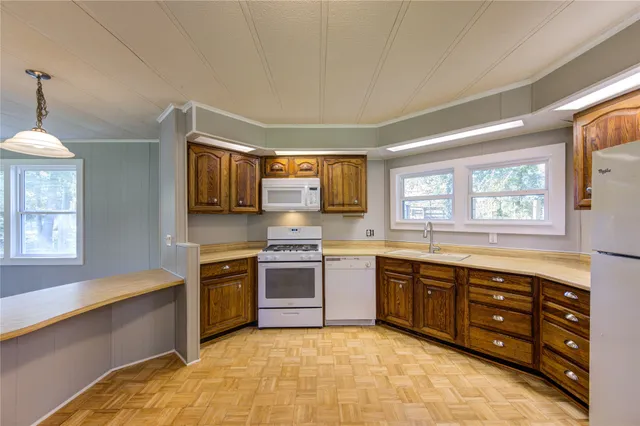 a large kitchen with stainless steel appliances granite countertop a stove and a sink