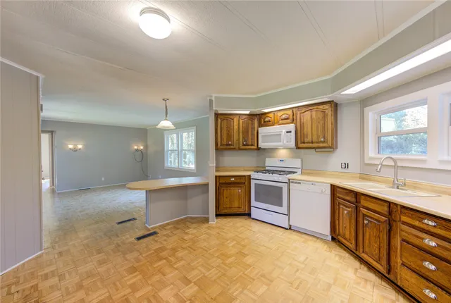 a large kitchen with kitchen island a sink stainless steel appliances and cabinets