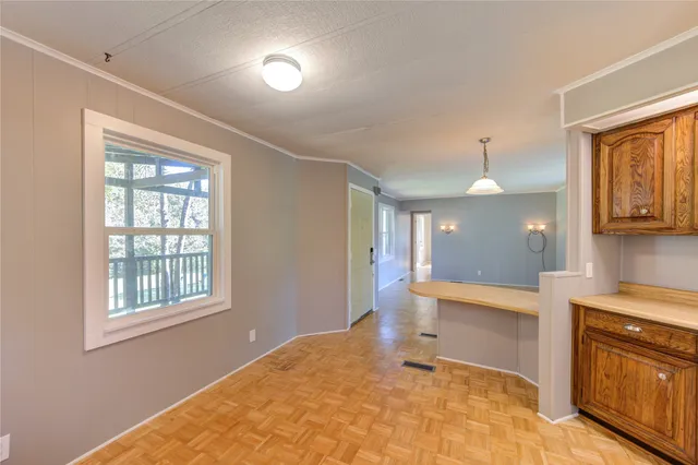 a view of a kitchen with a sink and a large window