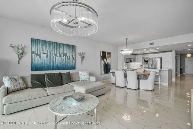 a living room with furniture and a chandelier