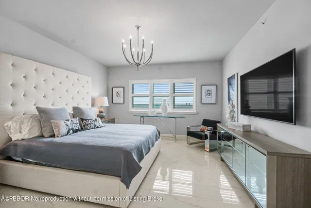 a spacious bedroom with a bed a window and dresser