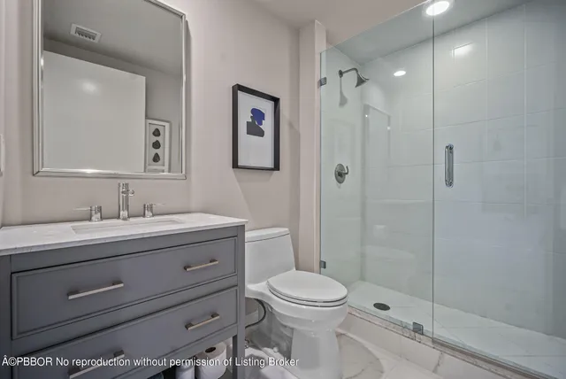 a bathroom with a toilet a sink and shower