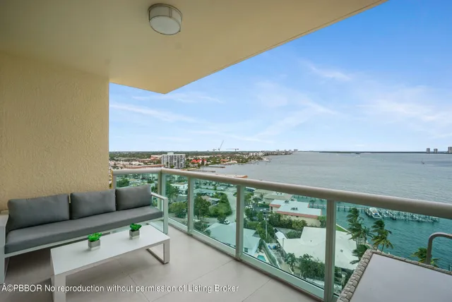 a view of a city from a balcony with furniture